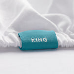 King fitted sheet color-coded tag detail close-up for quick size ID