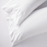 Set of two white king pillowcases with embroidered size line in 400-thread-count cotton, perfect for Airbnb beds