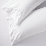 Set of two white king pillowcases with embroidered size line in 400-thread-count cotton, perfect for Airbnb beds