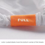 Full fitted sheet color-coded tag detail close-up for quick size ID