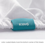 King fitted sheet color-coded tag detail close-up for quick size ID and easy placement