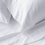 King sheet set lifestyle in white cotton, detail view for Airbnb hosts