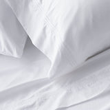 King sheet set lifestyle in white cotton, detail view for Airbnb hosts