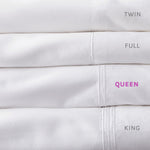 Stack of Fix Linens sheets showing embroidery differenced in sheet sizes. Queen is highlighted in pink type.