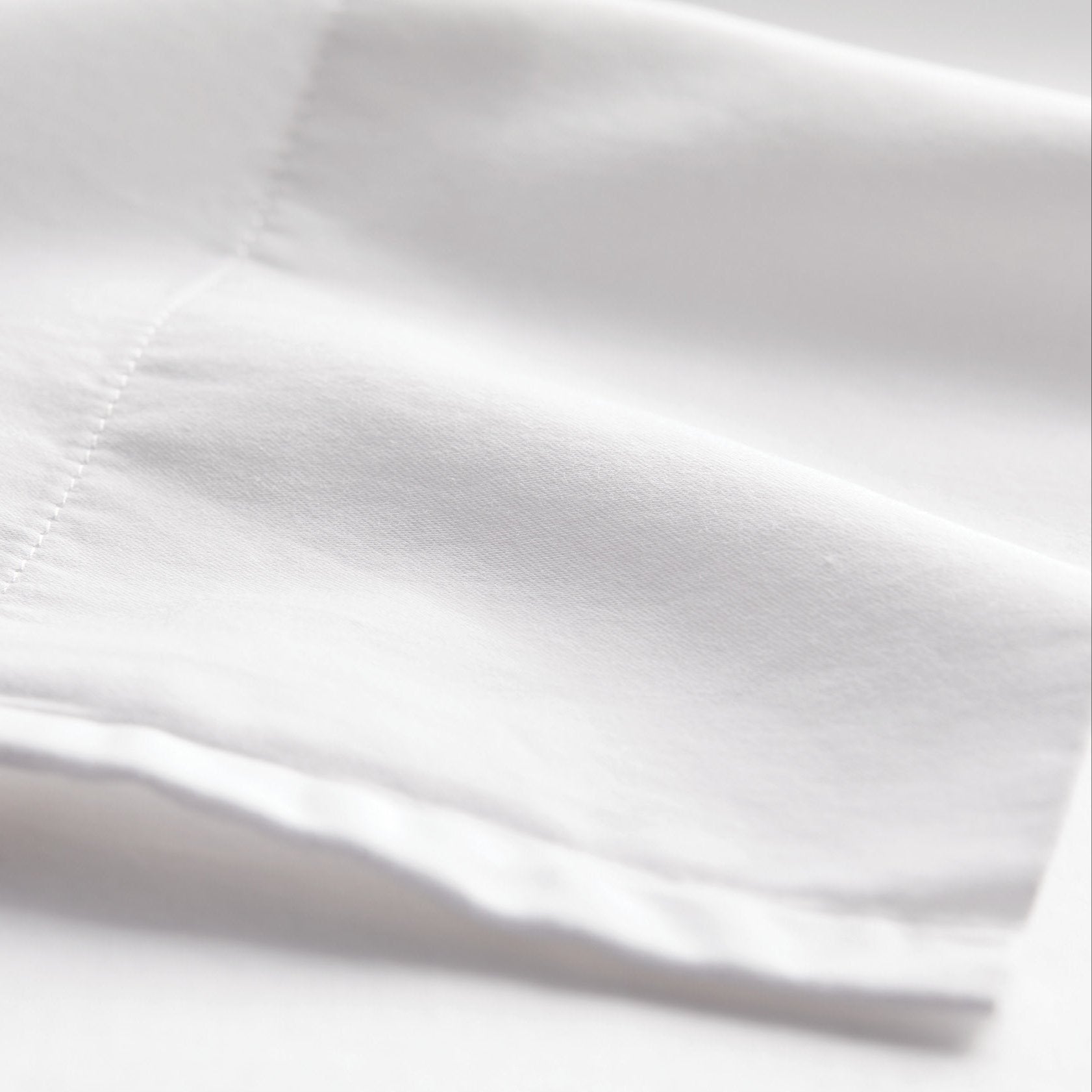 Twin sheet set detail in white cotton, fabric detail view for Airbnb hosts