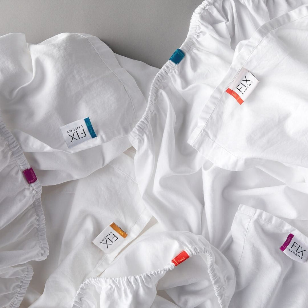 Fix Linens have color coded tags marking sizes for, pillowcase, flat sheet and fitted sheet and duvet covers. Easy sheets sorting system for white sheets.