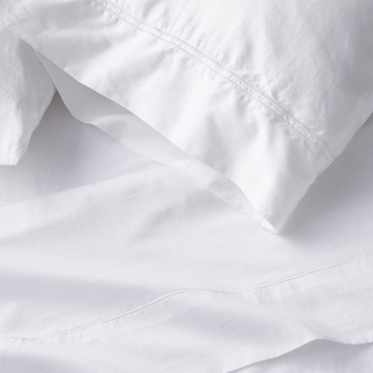 Full sheet set lifestyle in white cotton, detail view for Airbnb hosts