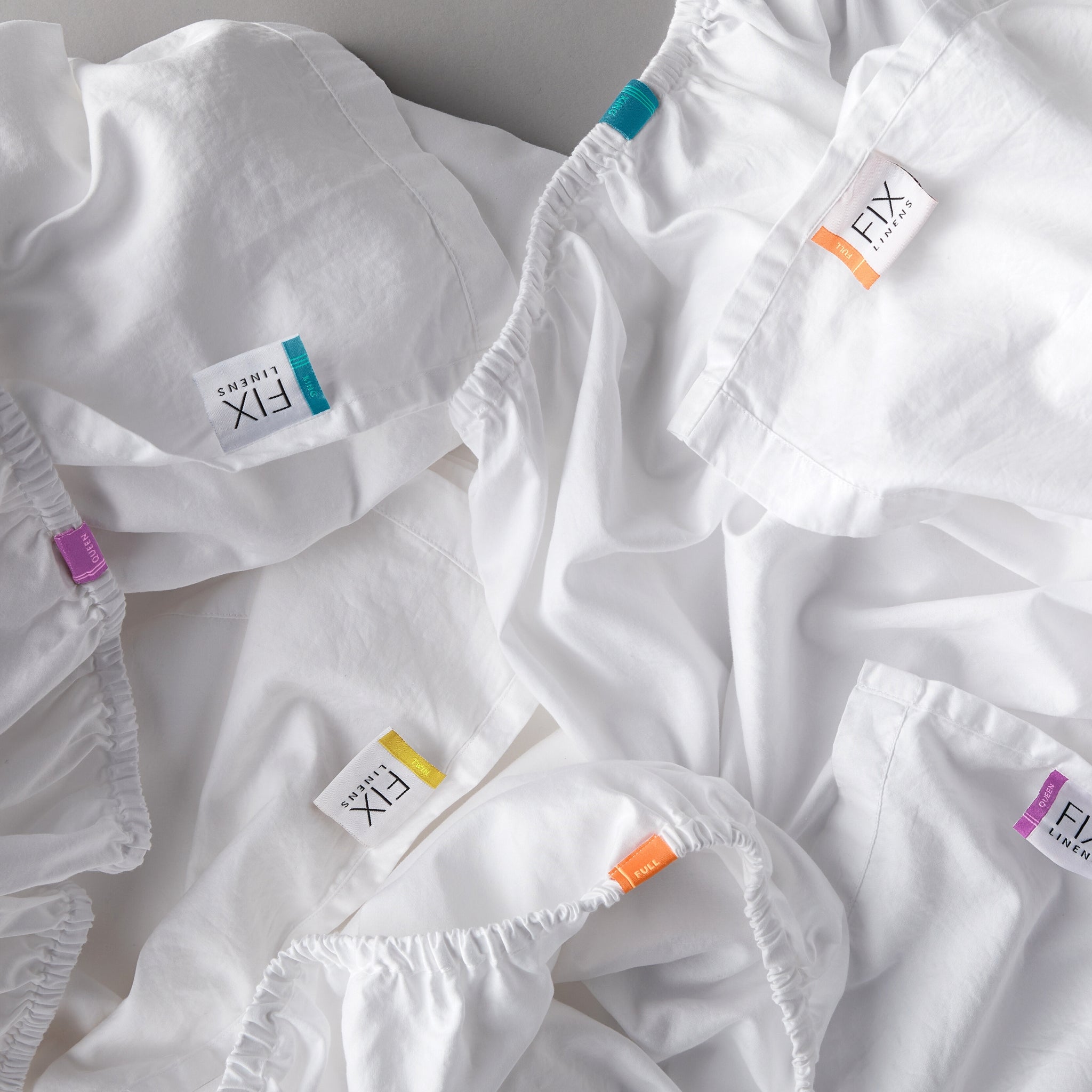 white sheets with colored tags indicating sheet sizes