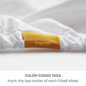 
                  
                    fix linens simple sort sheets. close up of fitted sheet with yellow tag making twin size and top center
                  
                