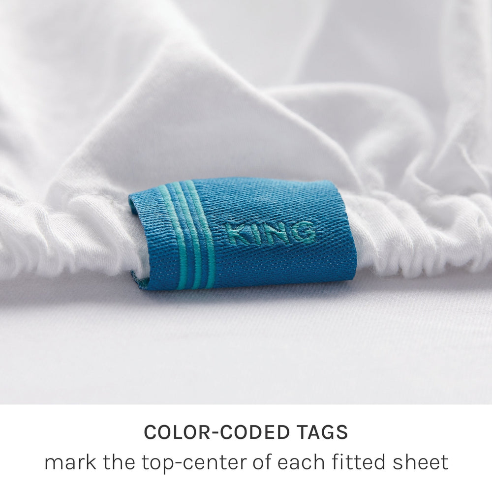 
                  
                    fix linens simple sort sheets. close up detail of a blue tag reading “KING”. This tag marks the top-center of the fitted sheet
                  
                